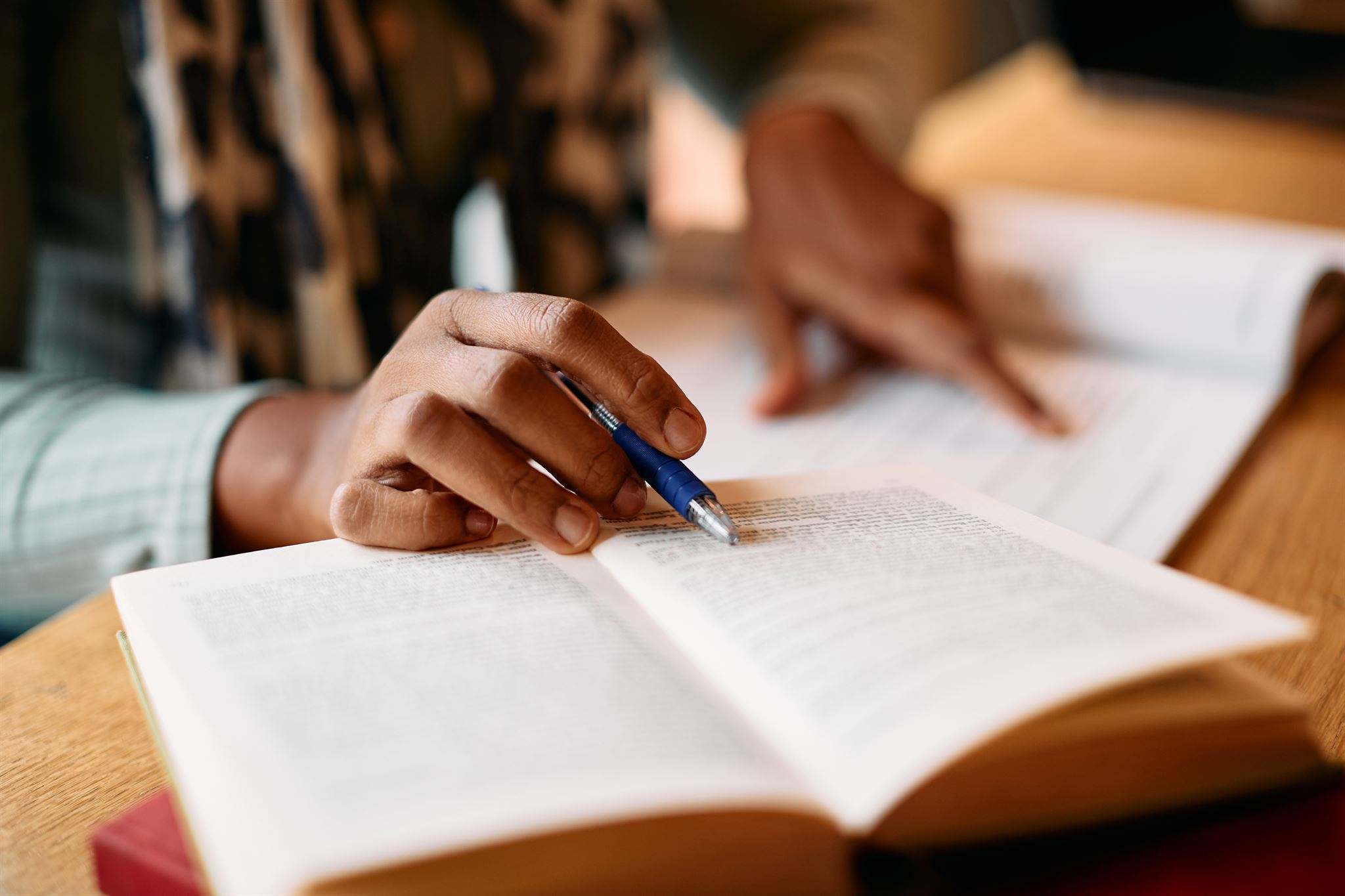 Closeup-of-hand-pointing-to-line-in-book